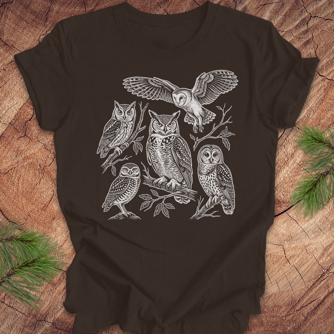 Brown t-shirt with white owl line-art illustrations on a wooden surface