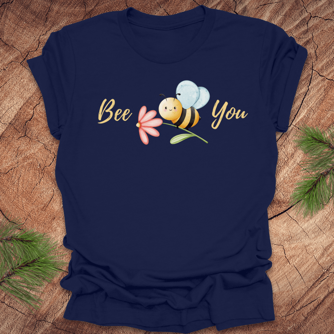 Navy blue tshirt with a cute bee and the text, "bee you" on a wooden background