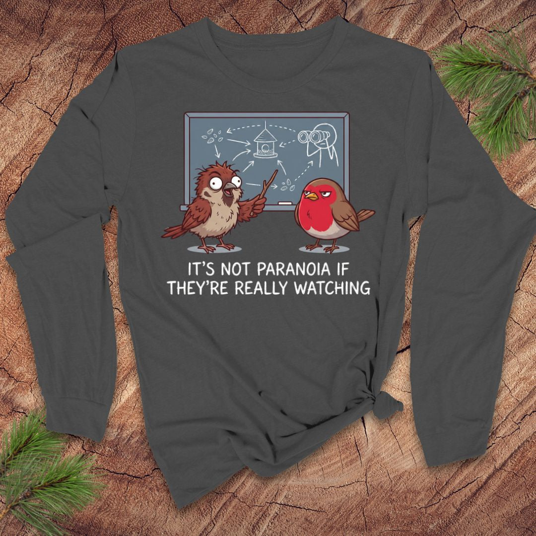 Gray long-sleeve shirt with cartoon birds and text on a wooden surface