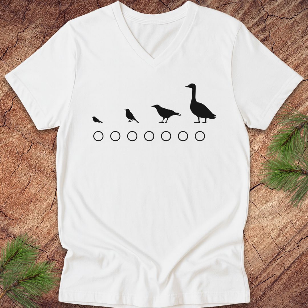 White t-shirt with black bird illustrations on a wooden surface