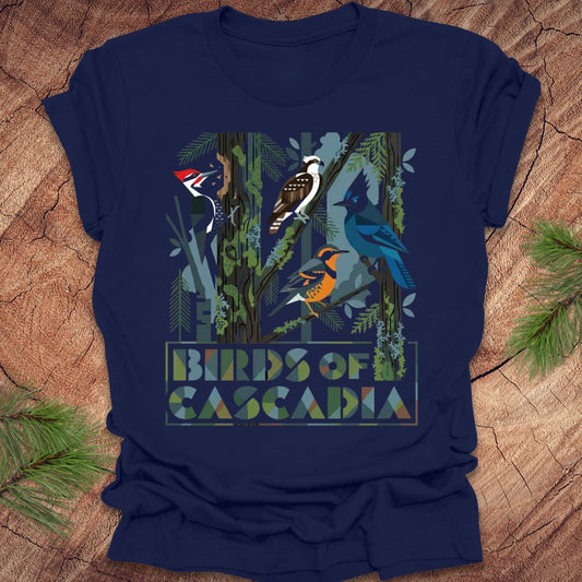 Navy blue t-shirt with bird graphic and 'Birds of Cascadia' text on a wooden surface.