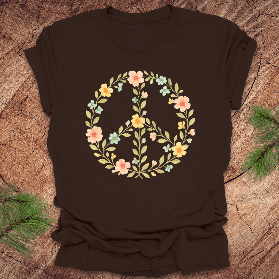 Brown t-shirt with a peace sign made of flowers on a wood background.