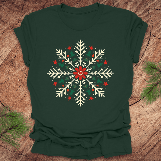 Green t-shirt with a colorful snowflake design on a wooden surface