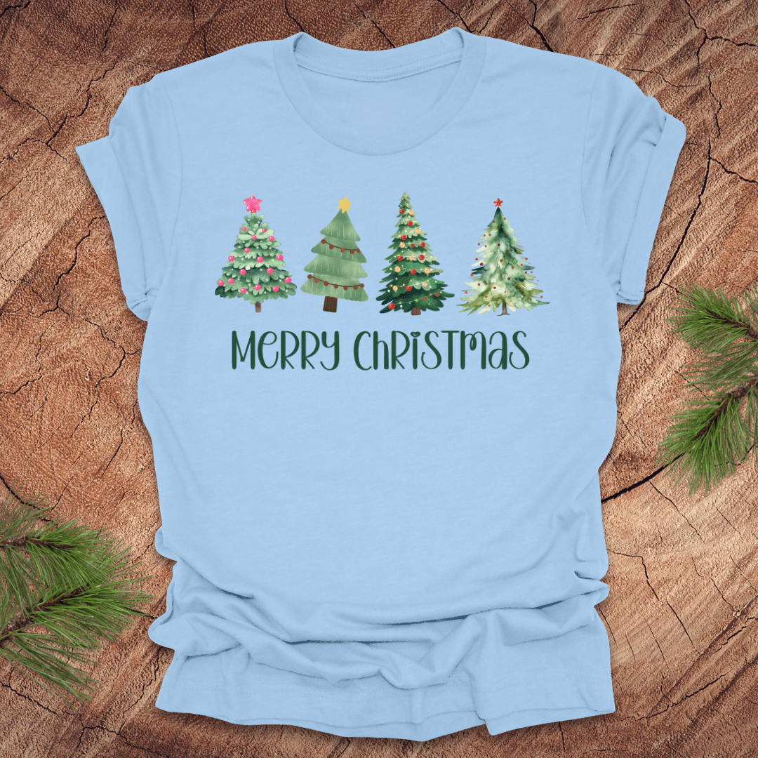 Baby blue tshirt with the text 'Merry Christmas' and christmas trees on a wood background.