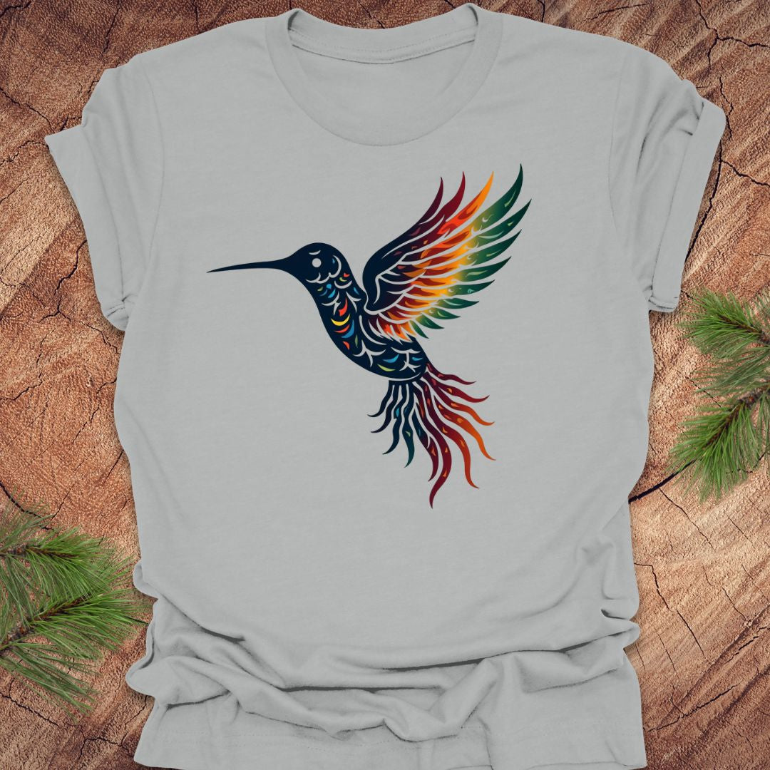 Gray t-shirt with a colorful hummingbird design on a wooden surface.