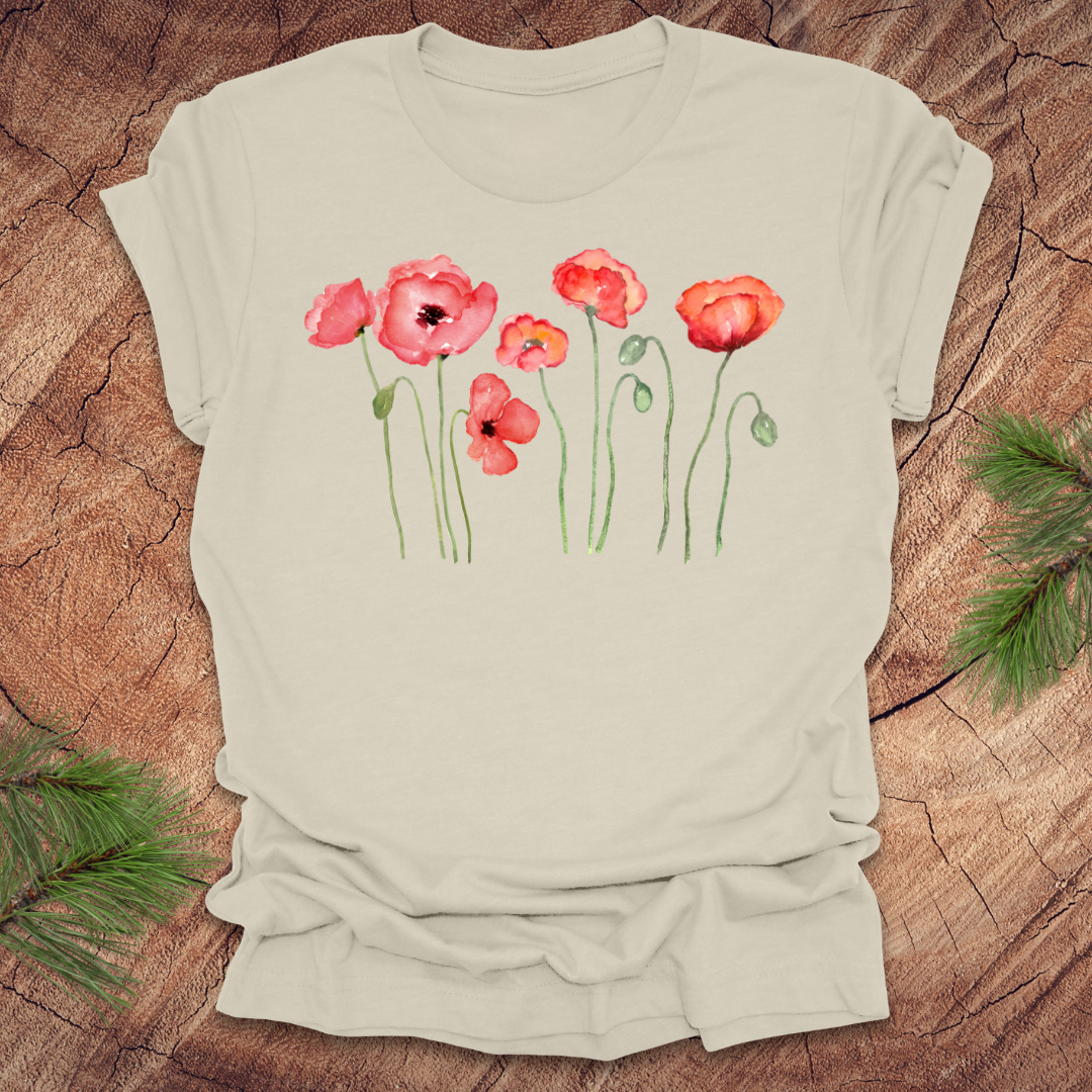 Beige t-shirt with red poppy design on a wooden surface
