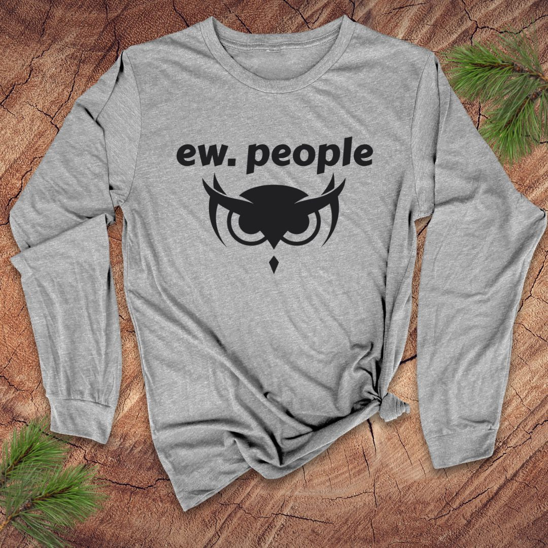 Gray long-sleeve shirt with 'ew. people' text and owl graphic on a wooden surface
