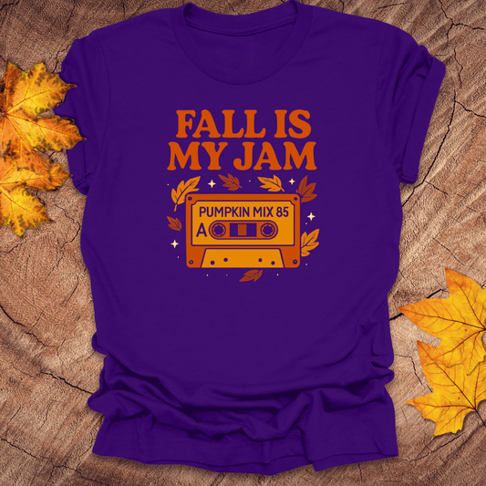 Purple t-shirt with 'Fall is my Jam' design featuring a cassette tape graphic on a wooden surface with fall leaves.