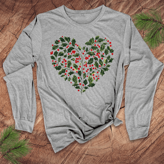 Grey long sleeve t-shirt with a heart-shaped holly design on a wooden surface
