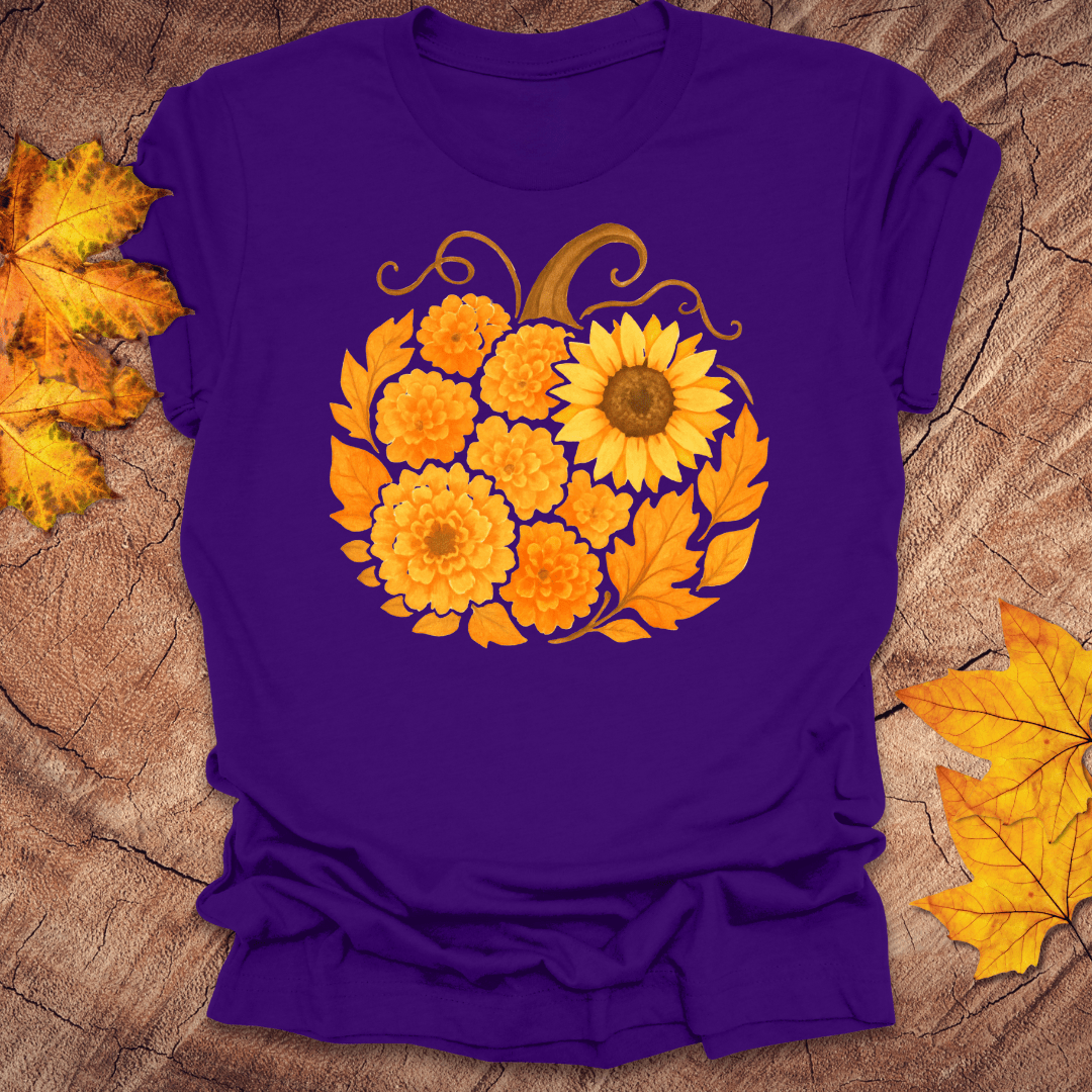 Purple t-shirt with a sunflower design on a wooden surface with fall leaves.