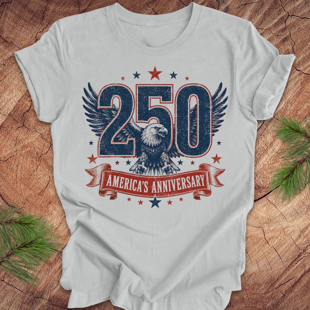 Gray t-shirt with '250 America's Anniversary' design featuring an eagle on a wooden surface.