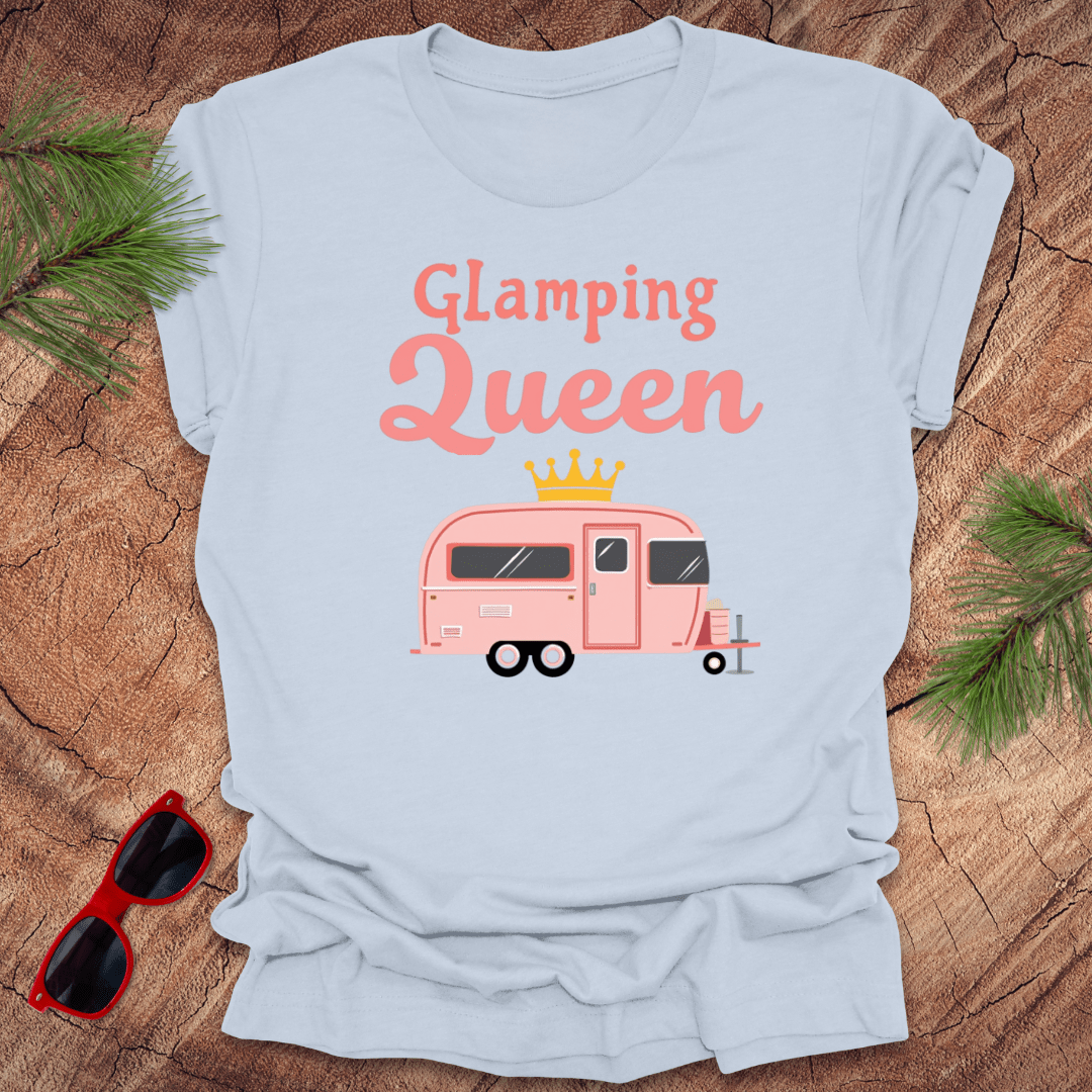 A light blue t-shirt with 'Glamping Queen' written in pink and a graphic of a pink caravan wearing a crown.