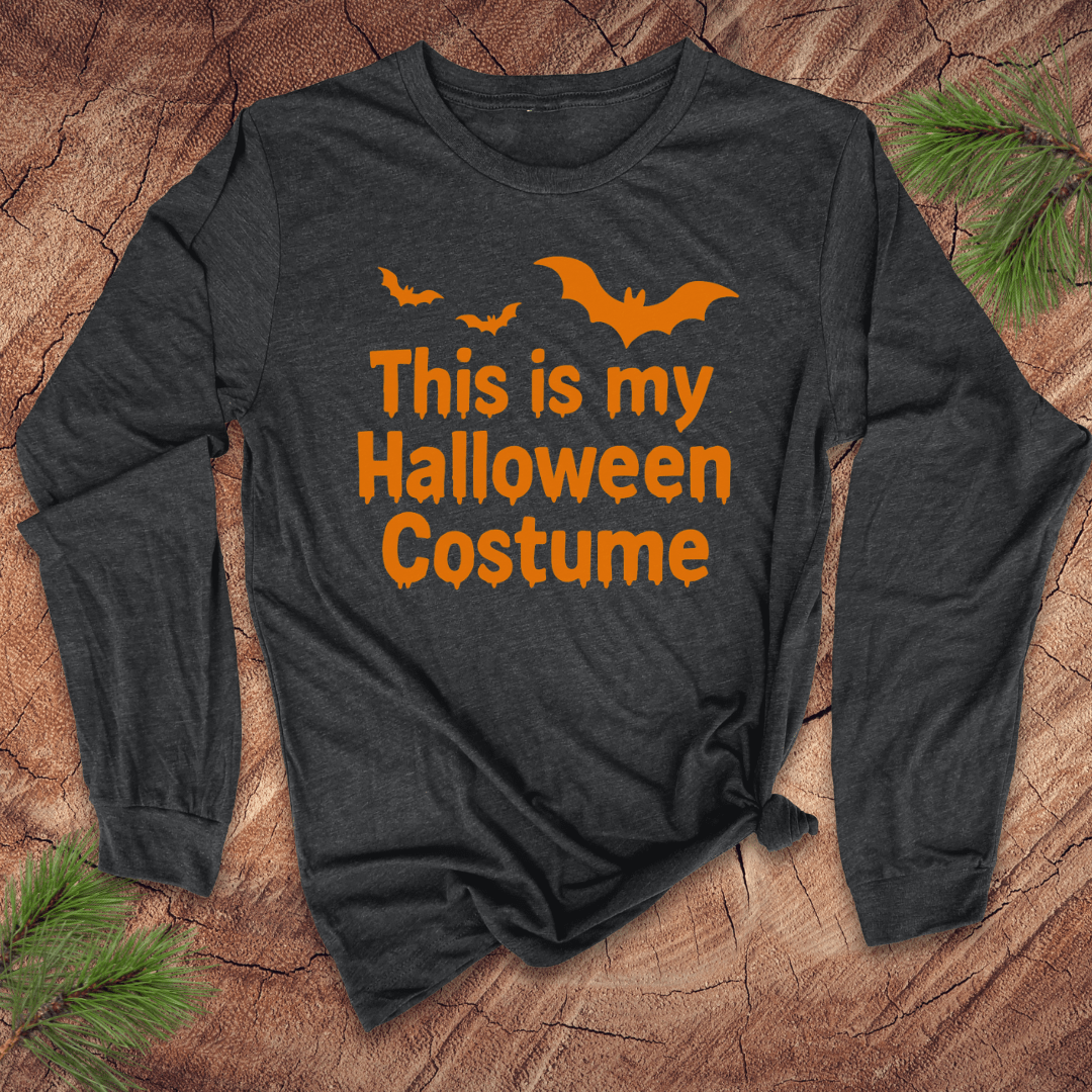 Dark gray long-sleeve shirt with orange text 'This is my Halloween Costume' and bat graphics on a wooden surface.