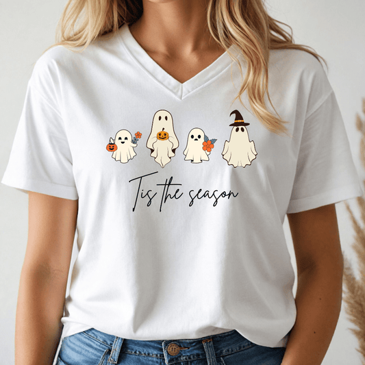 White t-shirt with Halloween-themed design featuring ghosts and text 'Tis the season', worn by a person.
