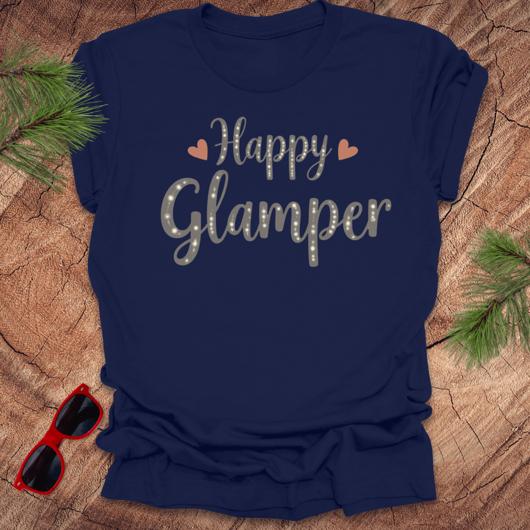 Navy blue t-shirt with 'Happy Glamper' text on a wooden surface with sunglasses and greenery.