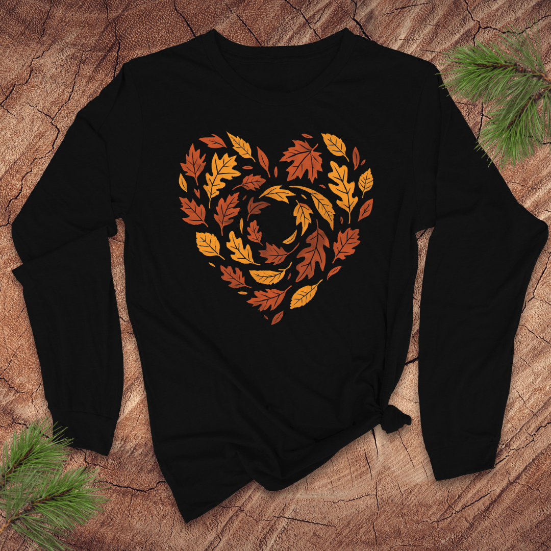 Black long sleeve tshirt with autumn leaf design in the shape of a heart on a wooden surface