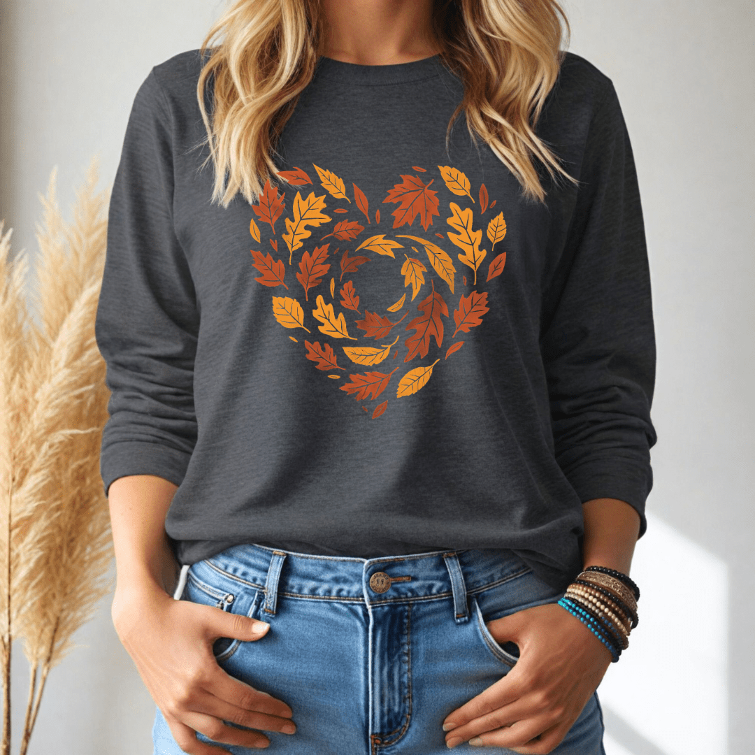 Person wearing a dark gray long sleeve shirt with autumn leaf design in the shape of a heart, standing against a neutral background.