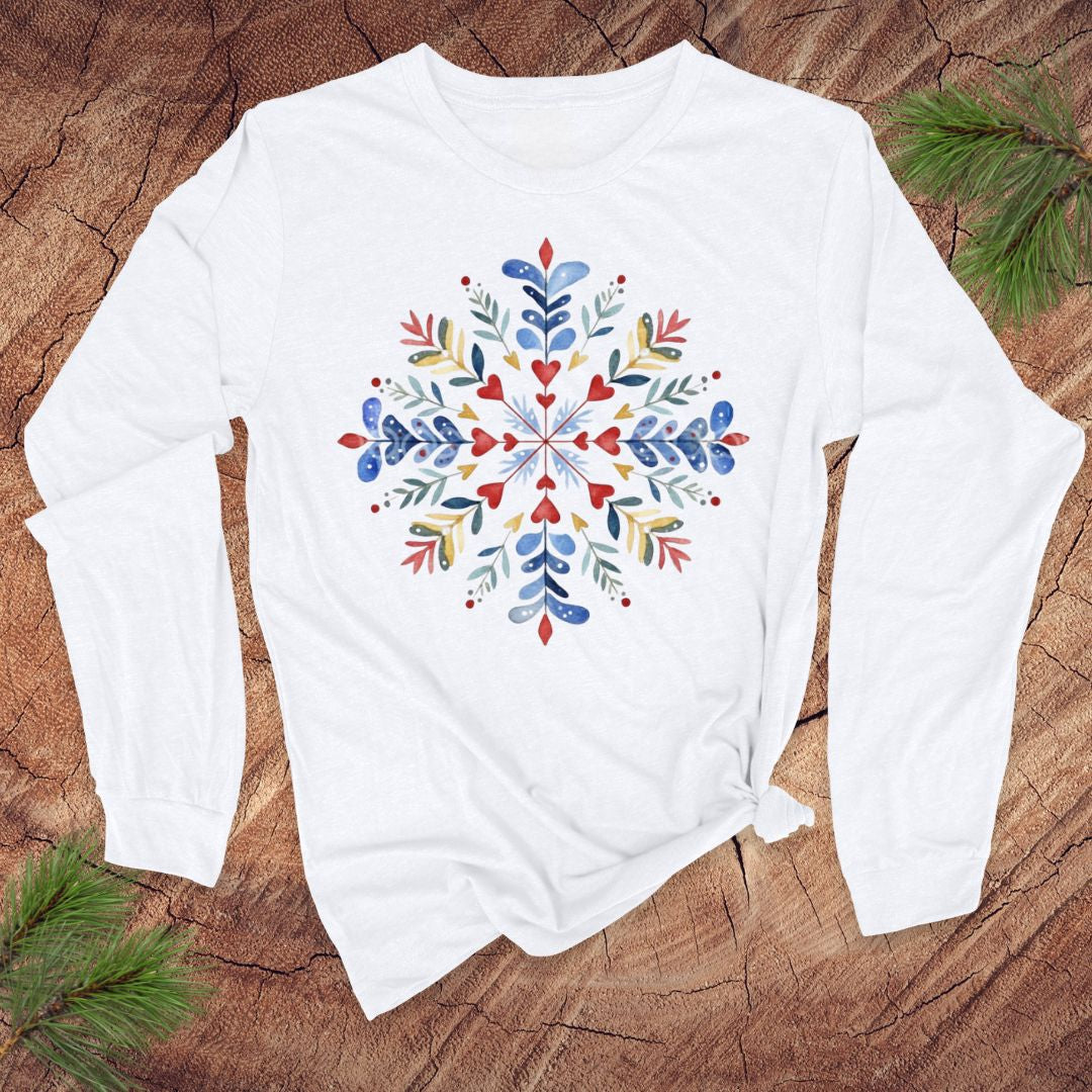 White long-sleeve shirt with a colorful floral pattern on a wooden surface