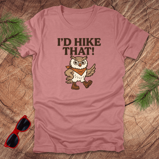 A mauve t-shirt with a graphic of an owl wearing a hat and the text 'I'D HIKE THAT!' printed above.