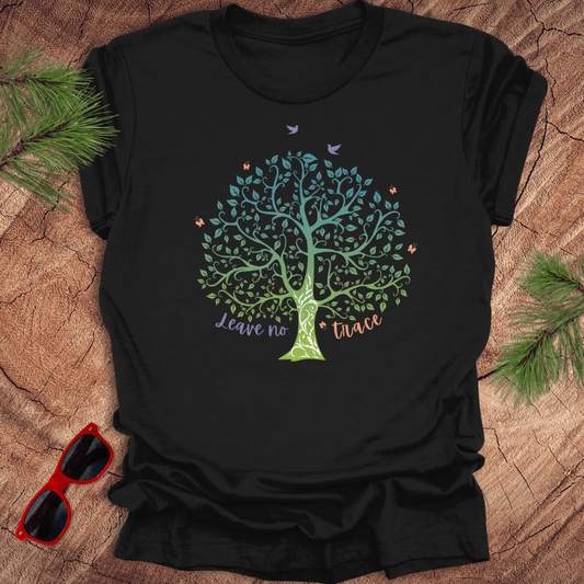 A black t-shirt with a graphic of a tree and the phrase 'Leave no Trace', surrounded by leaves and birds.