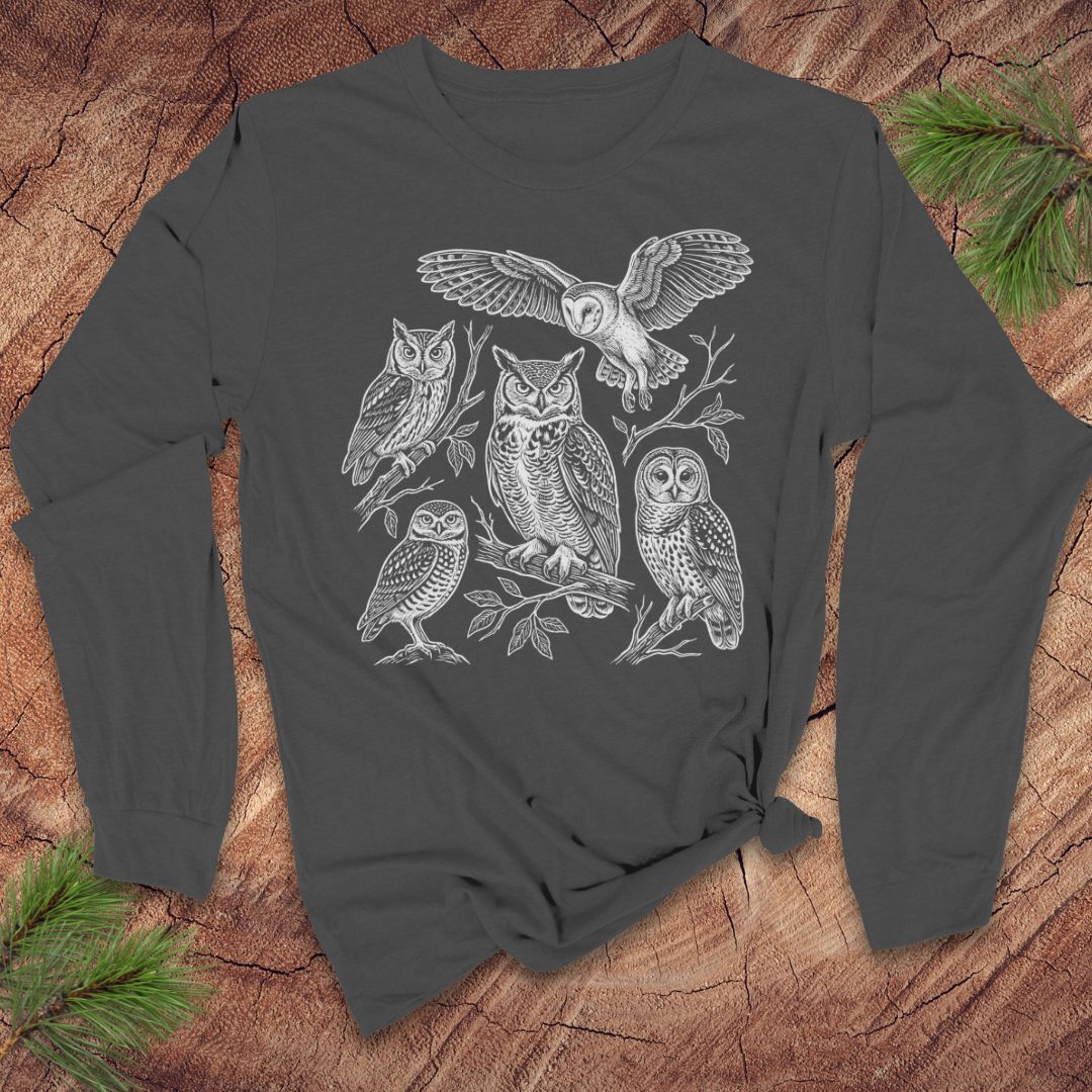 Gray long-sleeve tshirt with white owl design on a wooden surface