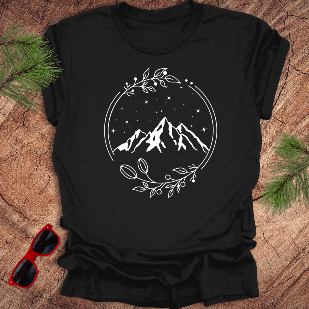 Black t-shirt with a graphic of a serene mountain scene surrounded by a circular frame, with stars and foliage accents.