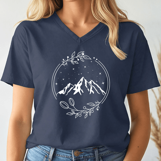 Navy blue t-shirt with mountain design worn by a person on a white background