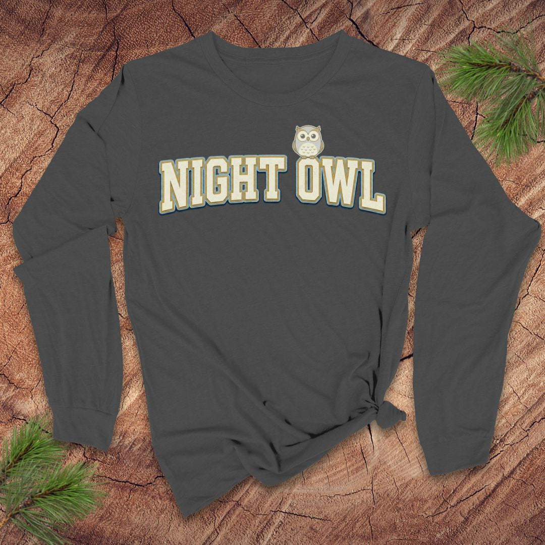 Gray long-sleeve shirt with 'NIGHT OWL' text and owl graphic on a wooden surface.