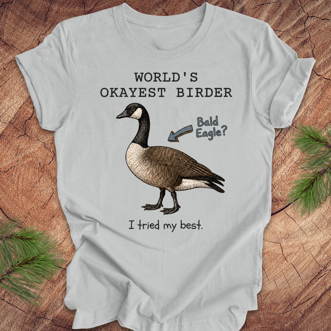 Gray t-shirt with a goose graphic and text on a wooden surface