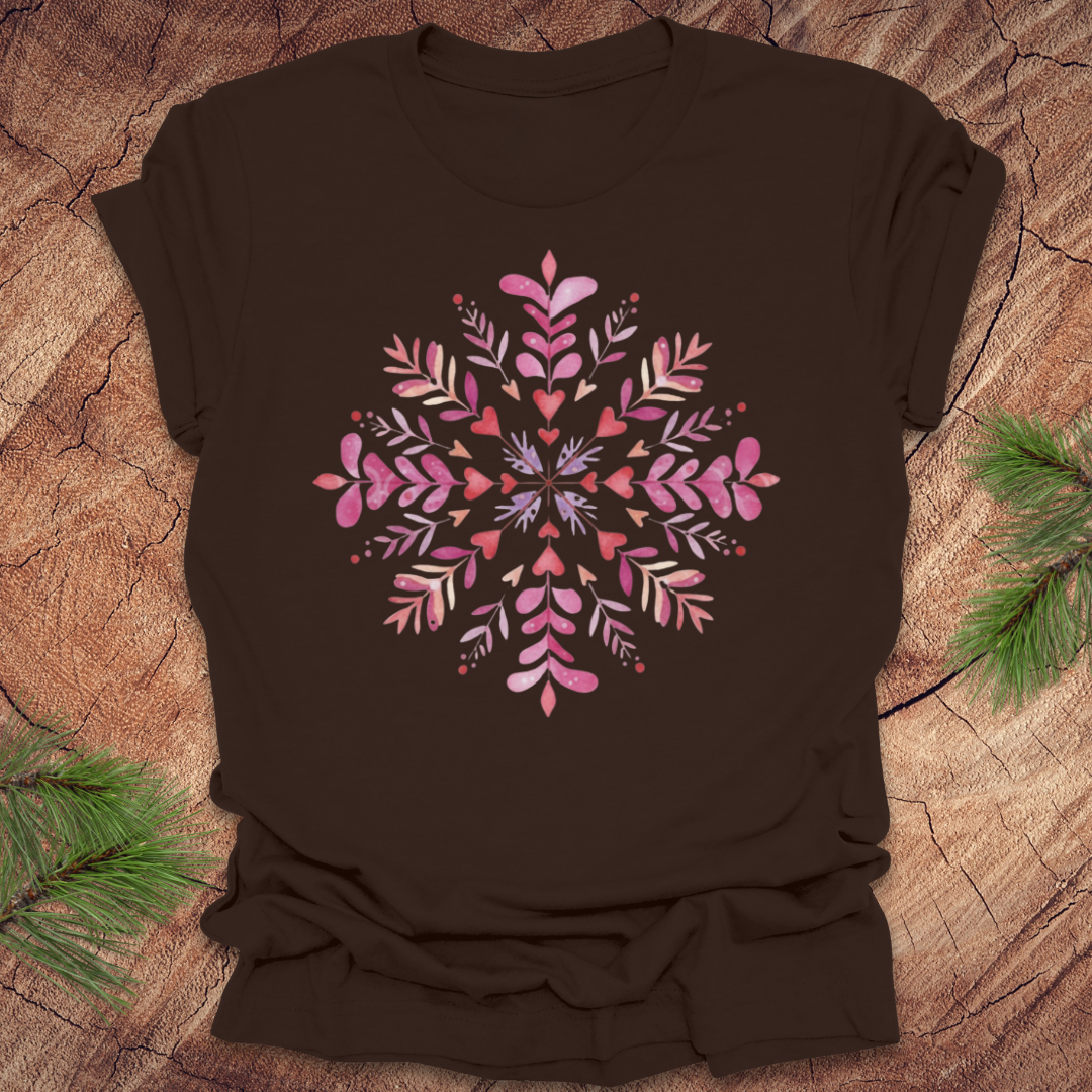 Brown t-shirt with pinkhearts and floral snowflake design on a wooden surface