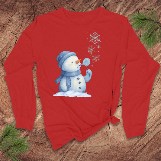 Red long-sleeve shirt with a snowman and snowflake design on a wooden surface