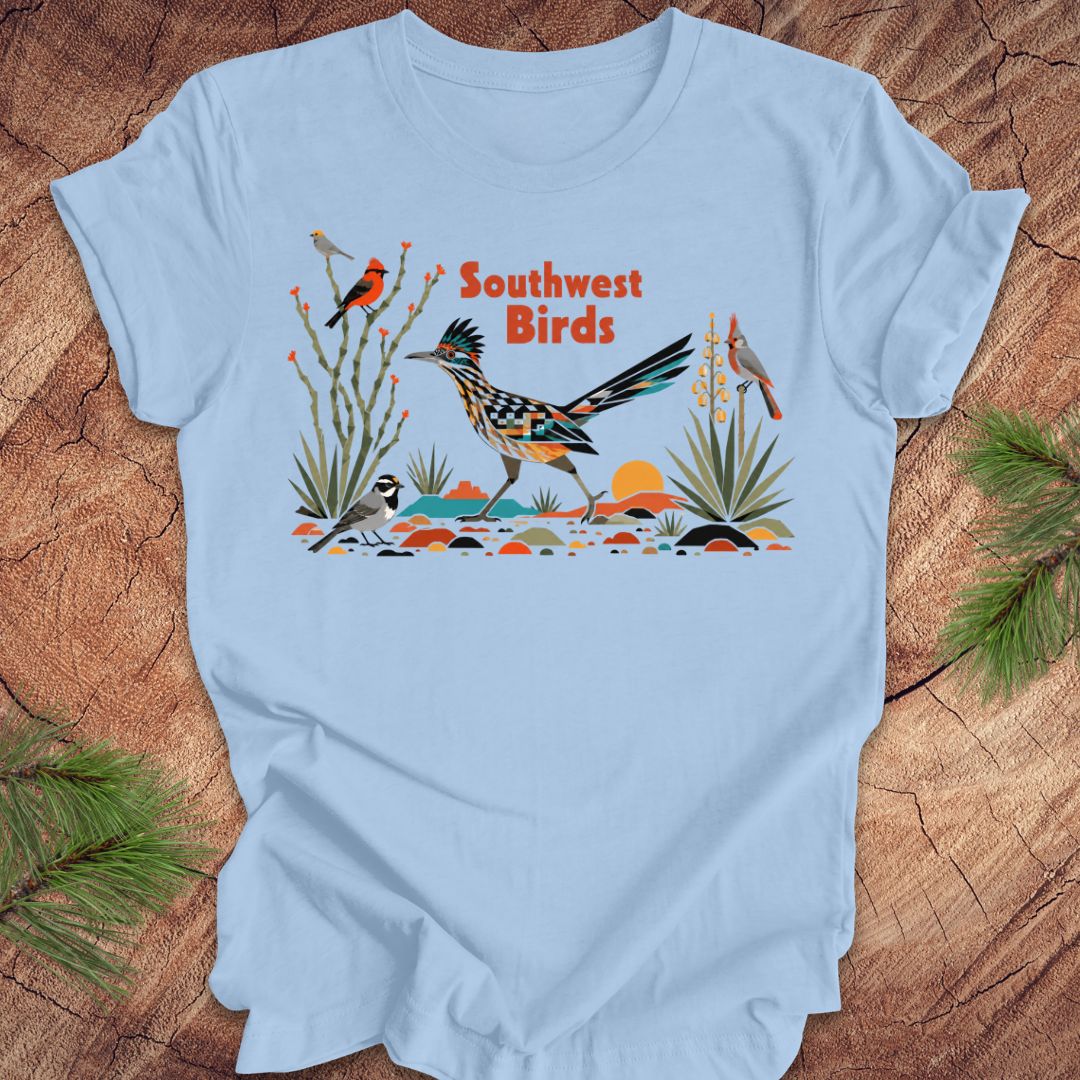 Light blue t-shirt with 'Southwest Birds' design on a wooden surface
