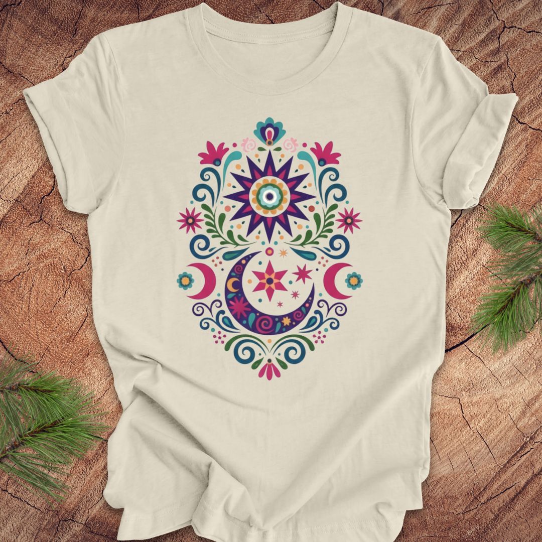 Beige t-shirt with colorful floral design on a wooden surface