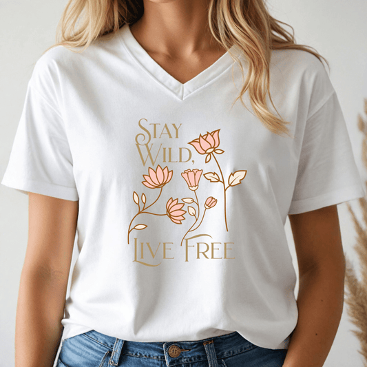 A person wearing a White v-neck t-shirt with 'Stay Wild, Live Free' text and floral design.