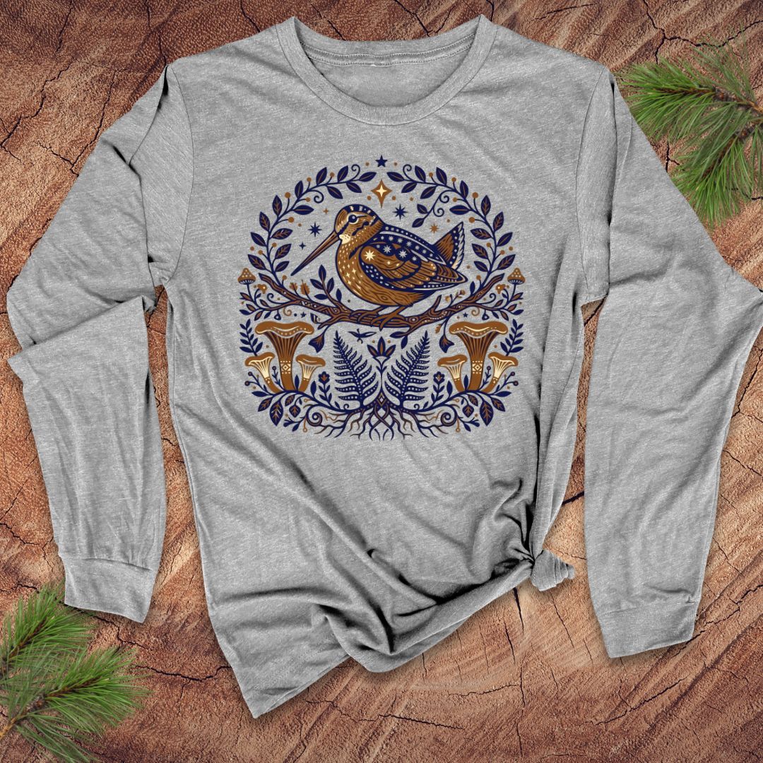 Gray long-sleeve shirt with a woodcock nature-themed design featuring a bird and plants on a wooden surface.