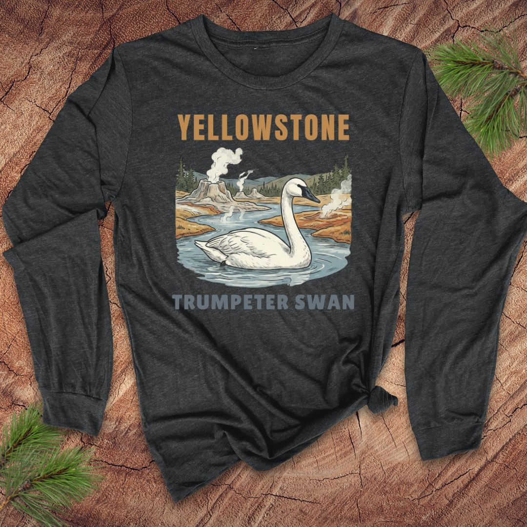 Dark gray long-sleeve shirt with Yellowstone and Trumpeter Swan design on a wooden surface