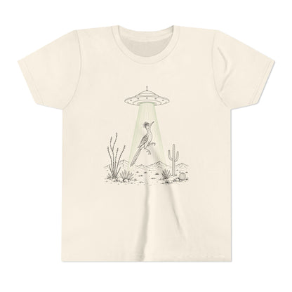 An off-white crewneck t-shirt featuring a minimalist graphic of a bird perched under a UFO with a green beam shining down on a desert landscape with cacti.