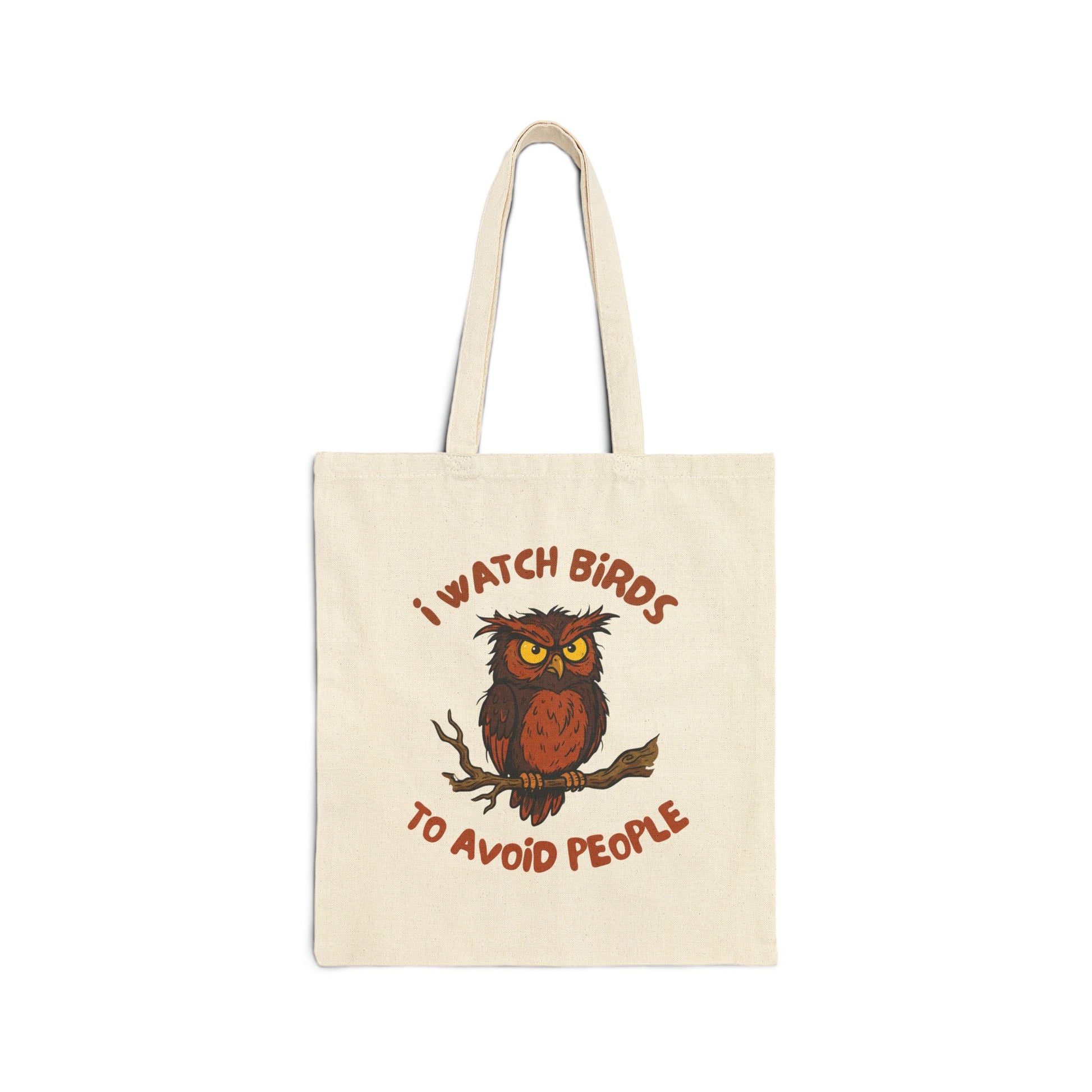 A canvas tote bag with owl design and text, 'i watch birds to avoid people' flat lay on a white background.
