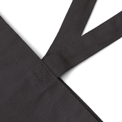 Black canvas tote bag fabric with a subtle pattern on a white background