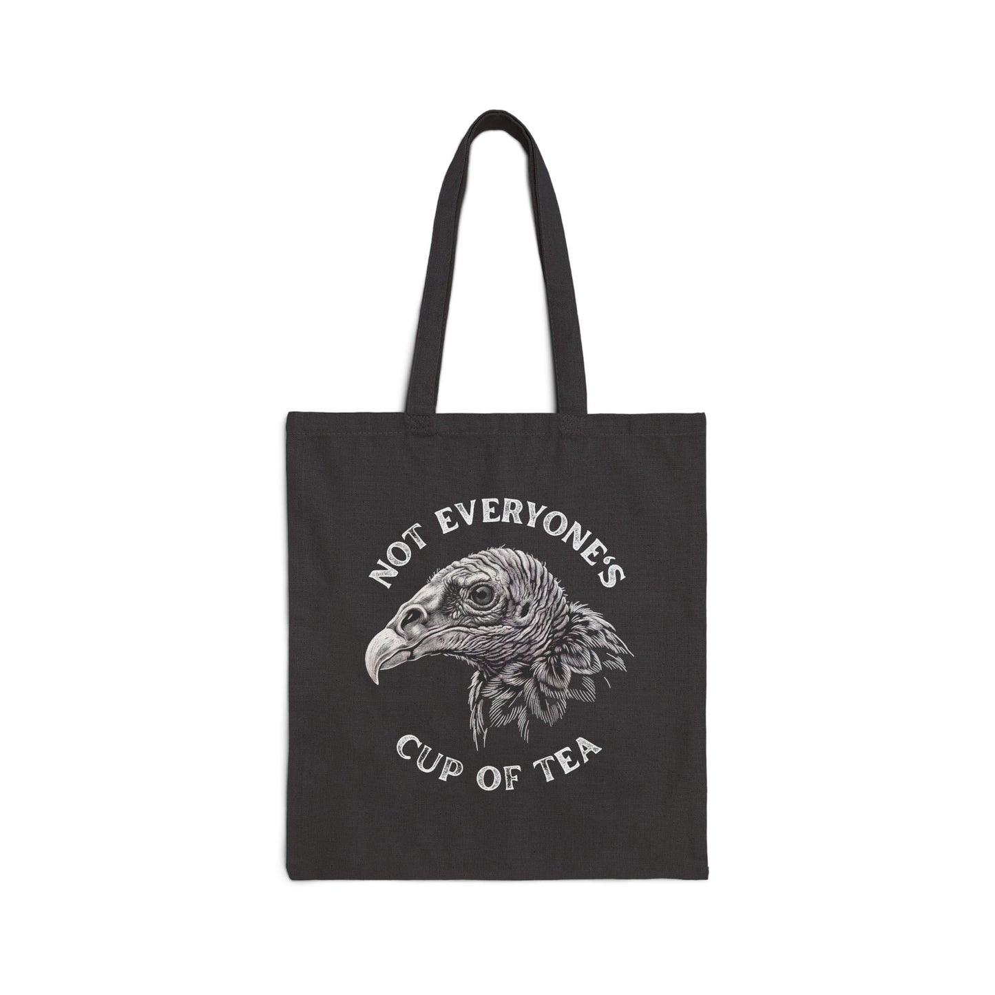 A black canvas tote bag with two black handles, featuring a white graphic of a vulture's head with the text 'NOT EVERYONE'S CUP OF TEA' printed around it, shown against a plain white background.