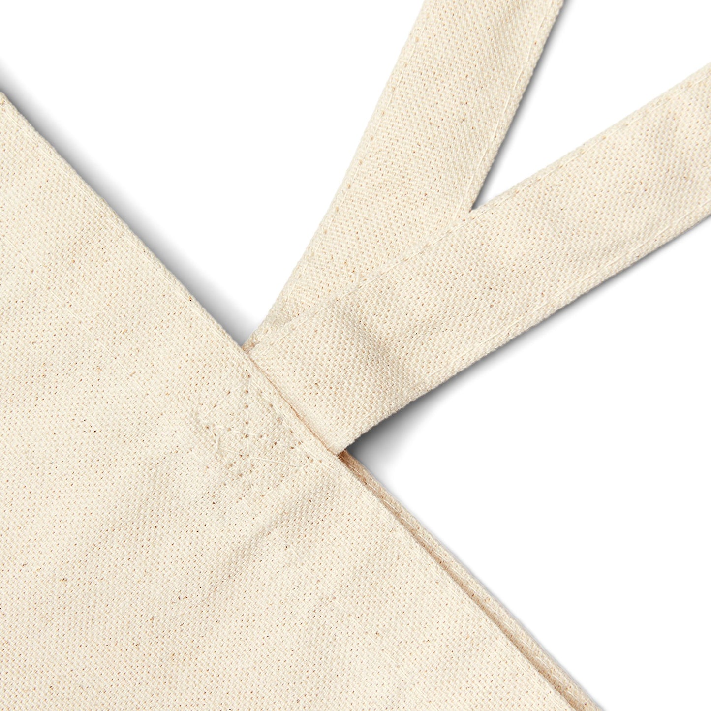 Close-up of beige canvas tote bag fabric straps on a white background