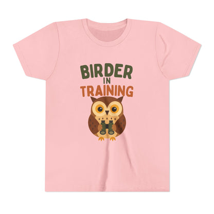 Pink t-shirt with an owl graphic and text 'Birder in Training' on a white background