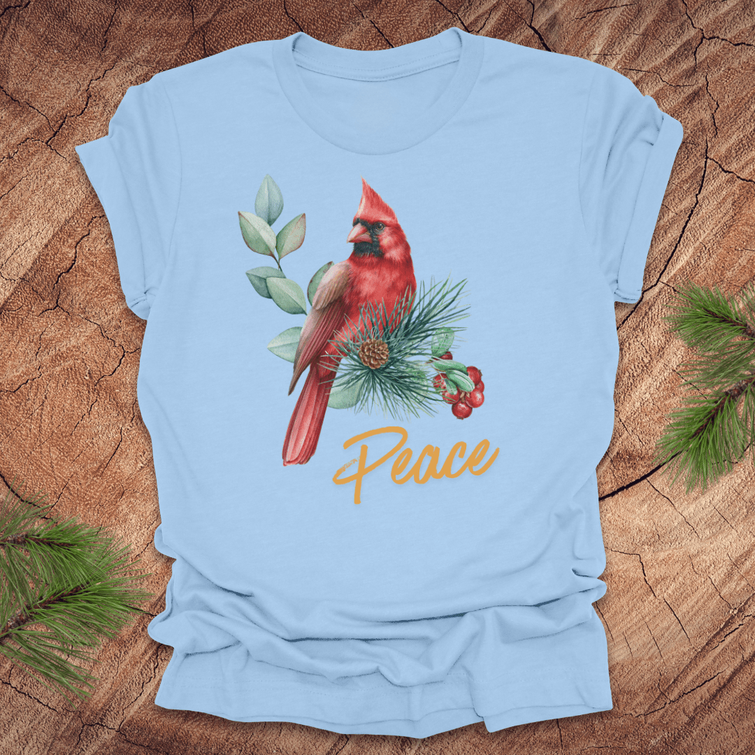 Light blue t-shirt with a red cardinal and 'Peace' text on a wooden surface