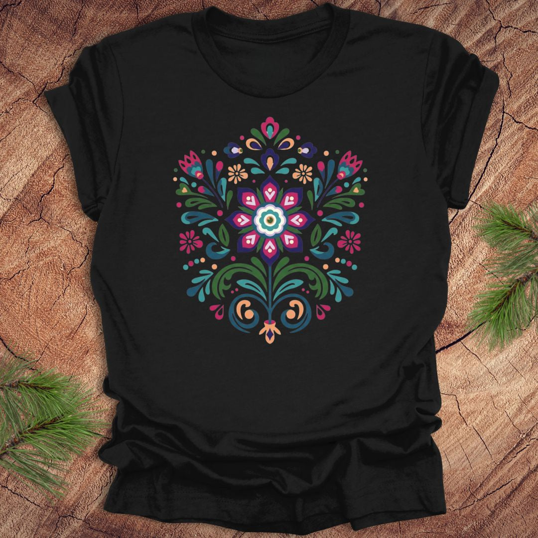 Black t-shirt with a colorful dutch inspired floral design on a wood background.