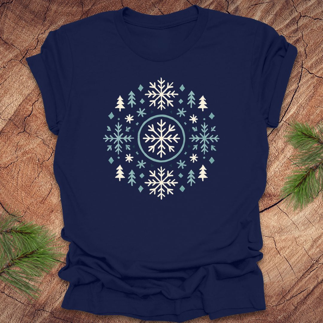 Navy blue t-shirt with snowflake and tree design on a wooden surface
