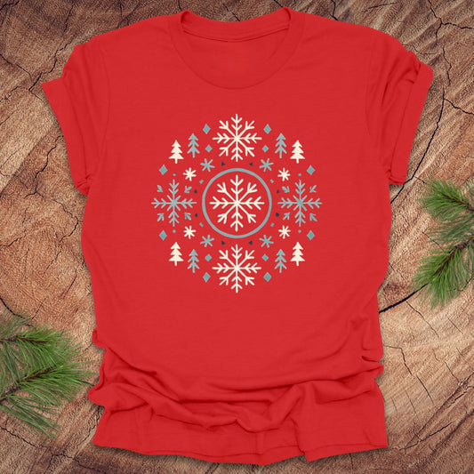 Red t-shirt with snowflake design on a wooden surface