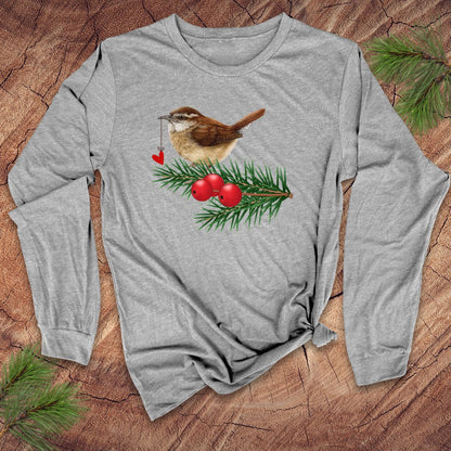 Grey long-sleeve shirt with a Christmas-themed design featuring a bird, berries, and pine branches on a wooden surface.