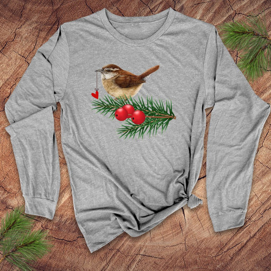 Grey long-sleeve shirt with a Christmas-themed design featuring a bird, berries, and pine branches on a wooden surface.