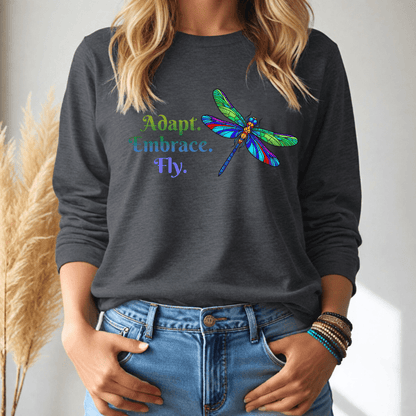 Person wearing a dark gray long-sleeve tshirt with a colorful dragonfly design and text.