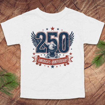 White t-shirt with '250 America's Anniversary' design featuring an eagle on a wooden surface.